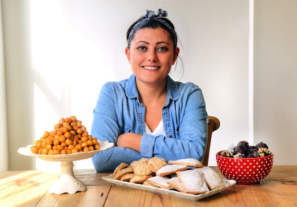 Caterina Scarano, who is from Italy and has lived in Atlanta since 2015, shared four recipes with The Atlanta Journal-Constitution: (from left) Purcidduzzi (fried cookies made with olive-oil dough), Brutti Ma Buoni (hazelnut meringues), Cuscini di Gesú Bambino (Baby Jesus Pillows, which are turnovers) and Panettone Truffles. STYLING BY CATERINA SCARANO / CONTRIBUTED BY CHRIS HUNT PHOTOGRAPHY