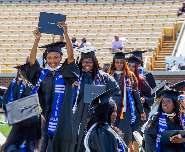 Kat Jackson shows off her diploma after earning her international studies degree in 2020. Spelman College holds commencement for the class of 2020 at Bobby Dodd Stadium on Sunday, May 16, 2021. Dr. Helene Gayle is the finalist to become Spelman's next president. (Jenni Girtman for The Atlanta Journal-Constitution