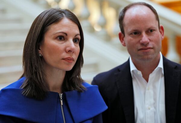 Democrat Stacey Evans, standing with her husband, Andrew, answers questions after she qualified for the governor’s race earlier this month. BOB ANDRES /BANDRES@AJC.COM