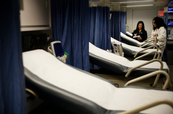 Nurses Kristy Haynes, left, and Crysta Swift look over supplies inside a mobile emergency room set up outside Grady Memorial Hospital to help handle the ever-growing number of flu cases in Atlanta, Monday, Jan. 29, 2018. 