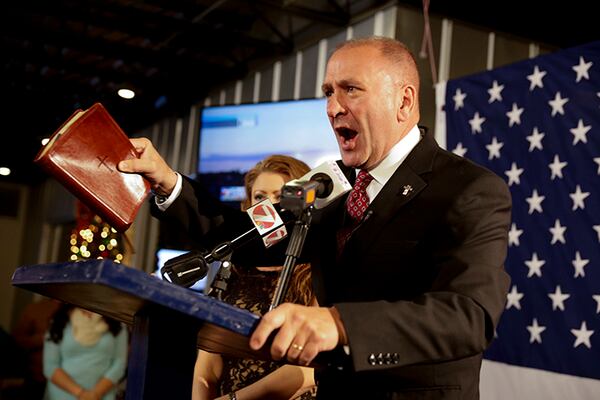 FILE - Higgins, with his wife, Becca, addresses supporters after his victory in Louisiana's 3rd congressional district run-off election in Lake Charles, La., in 2016.