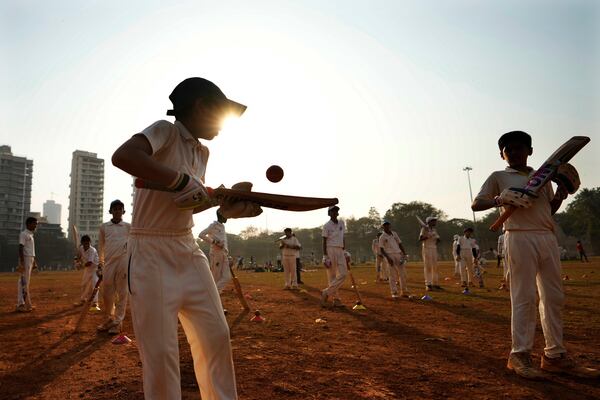 Indian children practice batting at a cricket coaching camp in Mumbai, India, Friday, Feb. 21, 2025. (AP Photo/Rajanish Kakade)