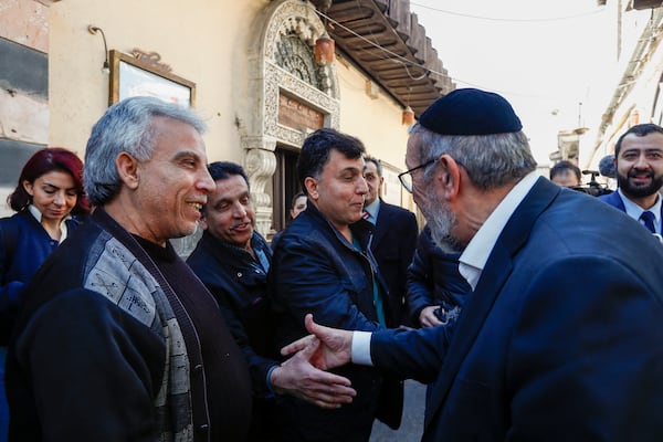 FILE - Rabbi Yusuf Hamra, right, is greeted by neighbours in the old city of Damascus Feb. 18, 2025. The Syrian-American Jewish family returned for the first time since emigrating from Syria to the United States more than three decades ago. (AP Photo/Omar Sanadiki, File)