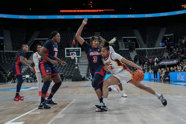 Southern California guard Juju Watkins drives against Mississippi's Kennedy Todd-Williams (3) during an NCAA college basketball game in Paris, France Monday, Nov. 4, 2024. (AP Photo/Aurelien Morissard)