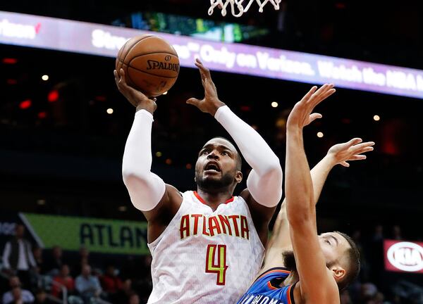 Atlanta Hawks forward Paul Millsap (4) goes up for a shot against Oklahoma City Thunder center Joffrey Lauvergne (77) in the first half of an NBA basketball game Monday, Dec. 5, 2016, in Atlanta. (AP Photo/John Bazemore)