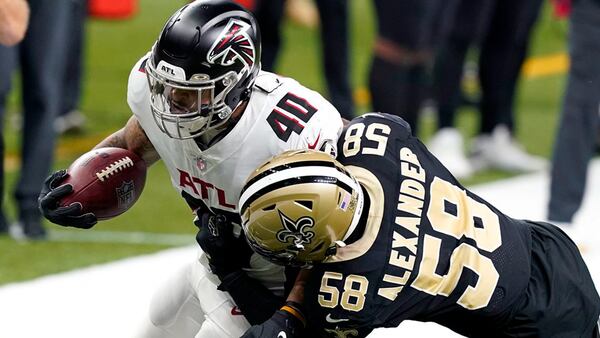 Falcons fullback Keith Smith (40) carries against New Orleans Saints outside linebacker Kwon Alexander (58) in the first half Sunday, Nov. 22, 2020, in New Orleans. (Butch Dill/AP)