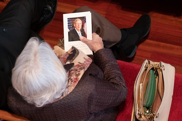 A woman holds a program before the beginning of Thursday's funeral for U.S. Sen. Johnny Isakson at Peachtree Road United Methodist Church in Atlanta. Ben Gray for the Atlanta Journal-Constitution