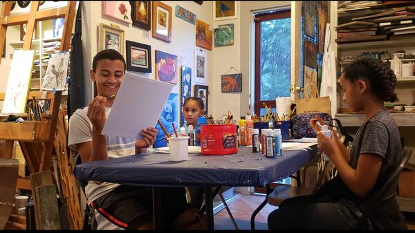 (From left to right) Dean Williams, 13, and his sisters, Makena, 5, and Dana, 12, do schoolwork from their home on a recent afternoon. More Hispanic children are being home-schooled by their parents. The Williams kids are Black and Hispanic. (Contributed photo) 