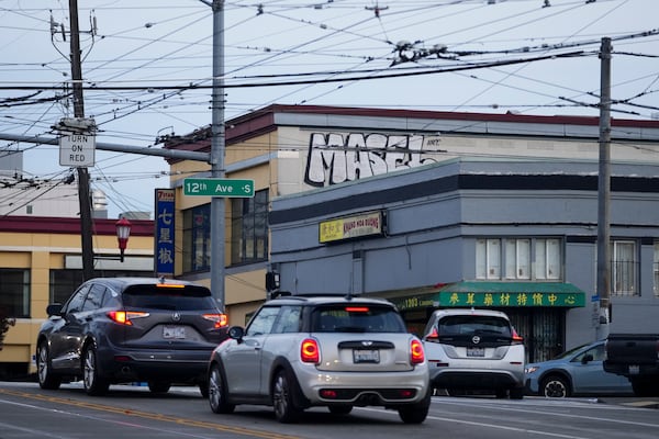 Drivers move through the area where multiple people were stabbed earlier Friday, Nov. 8, 2024, in the Chinatown-International District in Seattle. (AP Photo/Lindsey Wasson)