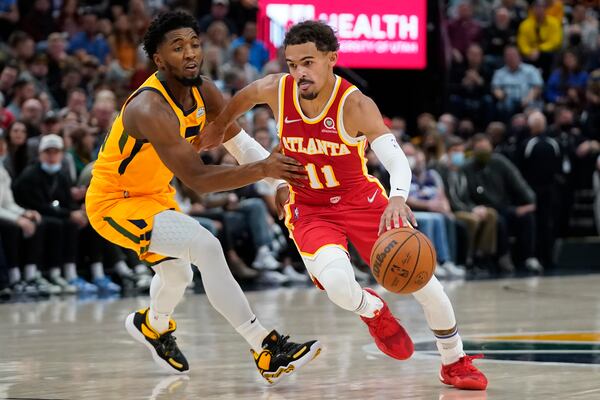 Atlanta Hawks guard Trae Young (11) drives around Utah Jazz guard Donovan Mitchell duirng the first half of an NBA basketball game Tuesday, Nov. 9, 2021, in Salt Lake City. (AP Photo/Rick Bowmer)