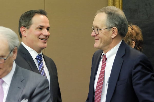 Defendants David Cohen (left) and John Butters (right) react to the “not guilty” verdicts in Fulton County Superior Court on Wednesday, April 11, 2018. Jurors decided that a sex video involving Waffle House chairman Joe Rogers Jr. was not recorded illegally. (Bob Andres bandres@ajc.com)