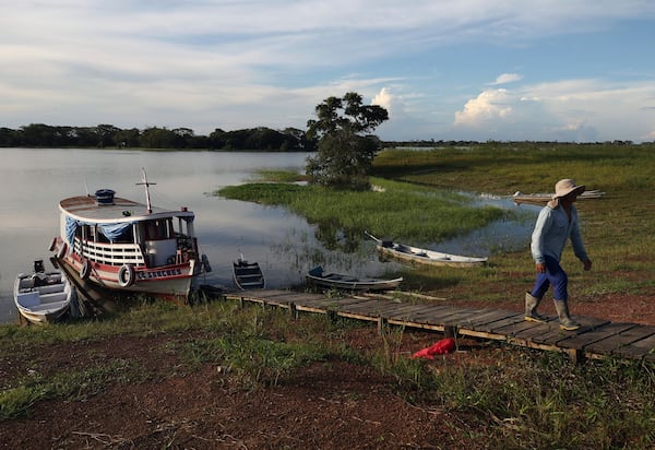 Vava Izague, a member of the Mura Indigenous community, disembarks in the Lago do Soares village, in Autazes, state of Amazonas, Brazil, Monday Feb. 17, 2025. (AP Photo/Edmar Barros)