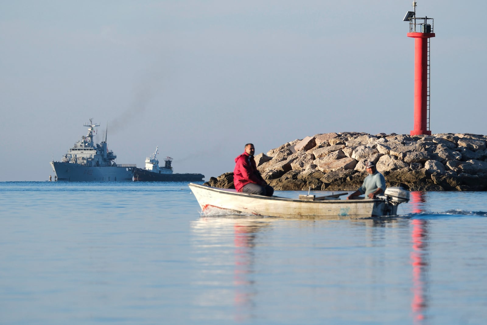 The Italian navy ship Libra, left, approaches the port of Shengjin, northwestern Albania, Friday, Nov. 8, 2024, with the second group of eight migrants intercepted in international waters to be processed there in a reception facility despite the failure with the first group last month.(AP Photo/Vlasov Sulaj)