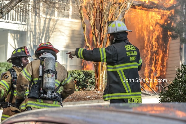 Flames were through the roof of the apartment building when the first DeKalb County fire crews arrived, officials said.