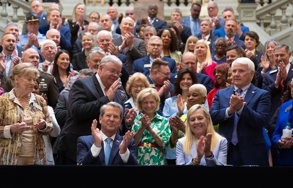 Gov. Brian Kemp (left) next to wife, Marty Kemp (right) on Tuesday, May 7, 2024 signed a $36.1 billion budget for fiscal 2025, which begins July 1. (John Spink/AJC)