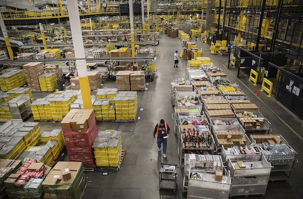 Employees fill online orders at the Amazon.com fulfillment center in Robbinsville, New Jersey, on Nov. 27, 2017. Bloomberg photo by Victor J. Blue