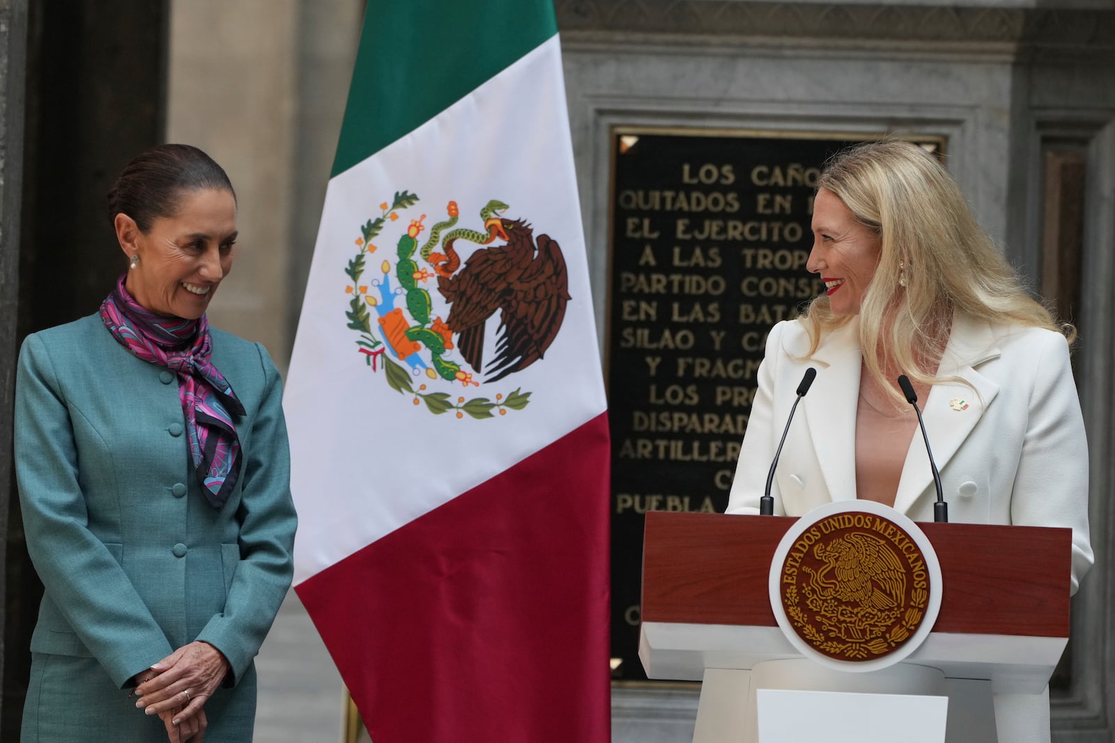 Mexican President Claudia Sheinbaum, left, stands with Sarah Bairstow, CEO of Mexico Pacific LLC, during a news conference at the National Palace in Mexico City, Tuesday, Oct. 15, 2024. (AP Photo/Fernando Llano)