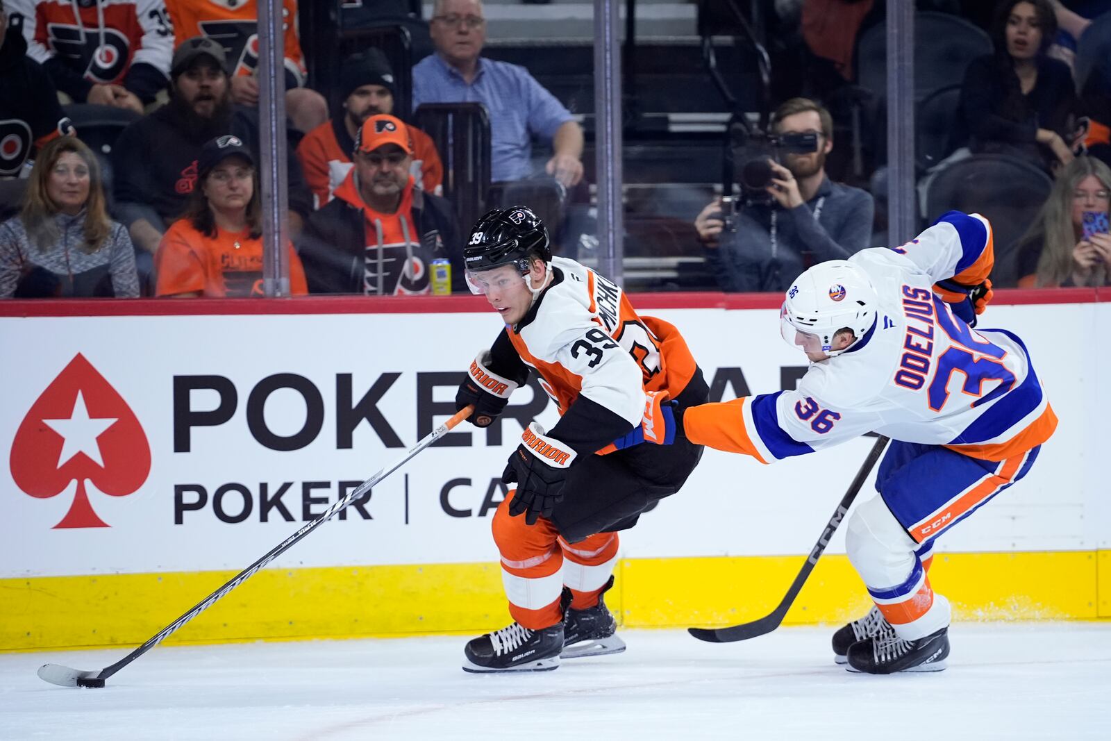 Philadelphia Flyers' Matvei Michkov, left, gets past New York Islanders' Calle Odelius during the second period of a preseason NHL hockey game, Thursday, Sept. 26, 2024, in Philadelphia. (AP Photo/Matt Slocum)