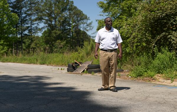 Ceasar Gaiters, CFO of Just About Blessing You, standing near the site of sinkholes forming on the grounds of Brannon Hill Condominiums in DeKalb on Tuesday, May 10, 2022. (Natrice Miller / natrice.miller@ajc.com)