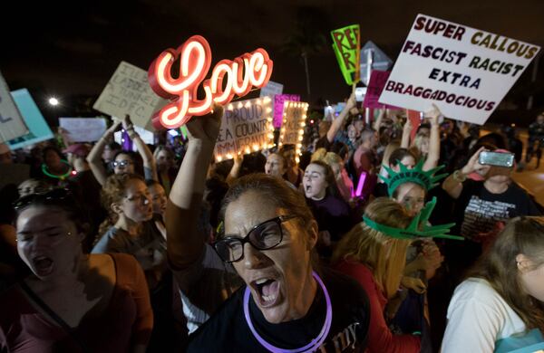 Protester Valerie Vrmeulen, Lake Worth, shouts during a peaceful protest outside the gates of Mar-a-Lago Saturday night. President Donald Trump was attending the Red Cross Ball at the winter White House in Palm Beach, Fl on February 4, 2017. (Allen Eyestone / The Palm Beach Post)