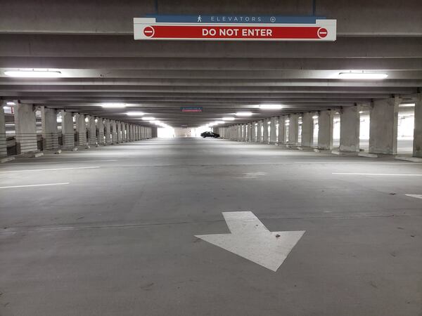 Months into the coronavirus pandemic, there are few vehicles in the parking decks at the Concourse office park in Sandy Springs during the work week. Many office workers are still telecommuting and it may be months more before some of them return to their corporate workstations. MATT KEMPNER / AJC