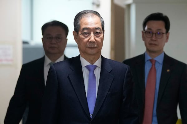 South Korean acting President Han Duck-soo, center, arrives to hold a briefing at the Government Complex in Seoul, South Korea, Monday, March 24, 2025. (AP Photo/Ahn Young-joon, Pool)