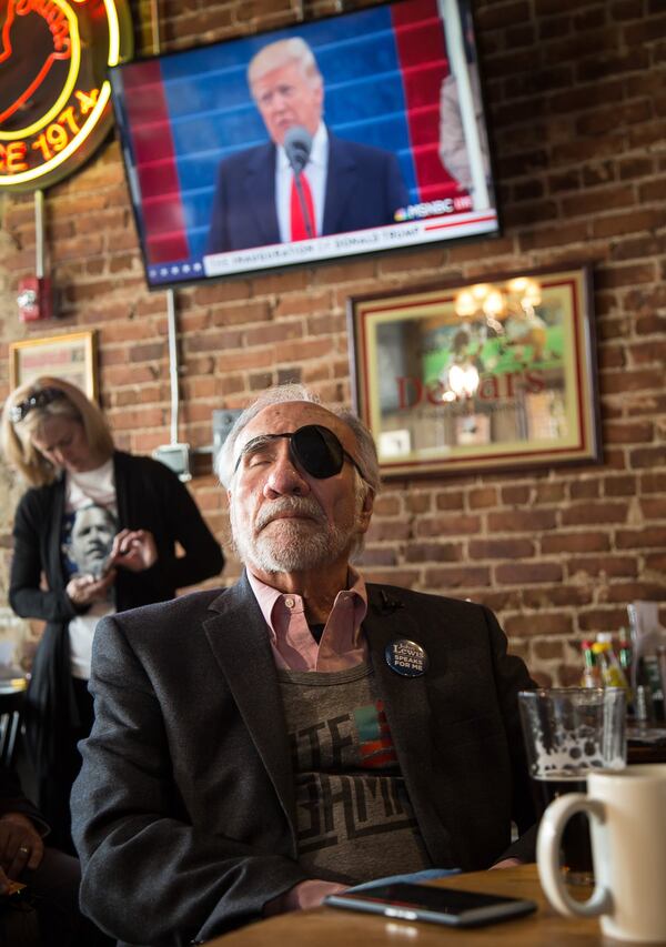 Angelo Fuster reacts as he watches new President Donald J. Trump give a speech on one of the many televisions at Manuel’s Tavern on Friday in Atlanta. STEVE SCHAEFER / SPECIAL TO THE AJC