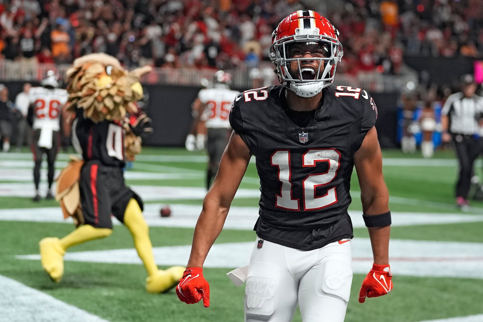 Atlanta Falcons wide receiver KhaDarel Hodge (12) celebrates after scoring the game-wining touchdown against the Tampa Bay Buccaneers during overtime in an NFL football game Friday, Oct. 4, 2024, in Atlanta. (AP Photo/John Bazemore)