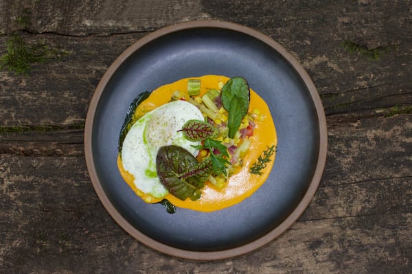 Succotash with Tomato Gravy garnished here with red sorrel, mizuna and other fresh herbs cultivated by Asheville, North Carolina farmer Evan Chender. (Courtesy of Becky Seymour)