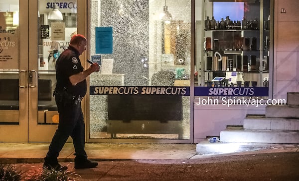 Bullets also shattered the glass storefront of a Supercuts on Spring Street and hit three cars parked nearby.