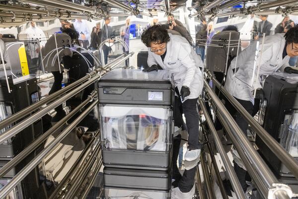 Chemical Insights Research Institute Dr. Qian Zhang makes adjustments to a 3D printer during testing in an exposure chamber at their Marietta research facility on March 26, 2024. (Steve Schaefer/steve.schaefer@ajc.com)