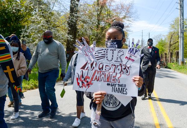 Decatur resident Amani Saleem (holding sign "Our Ancestors Matter") marches along Bolton Road to the site of the former Chattahoochee Brick Company during a sacred event to commemorate the lives lost during the period the company used the convict lease system. The event also included prayers, community testimonials and site consecration Saturday, April 3, 2021, in Atlanta. (Photo: Daniel Varnado for The Atlanta Journal-Constitution)