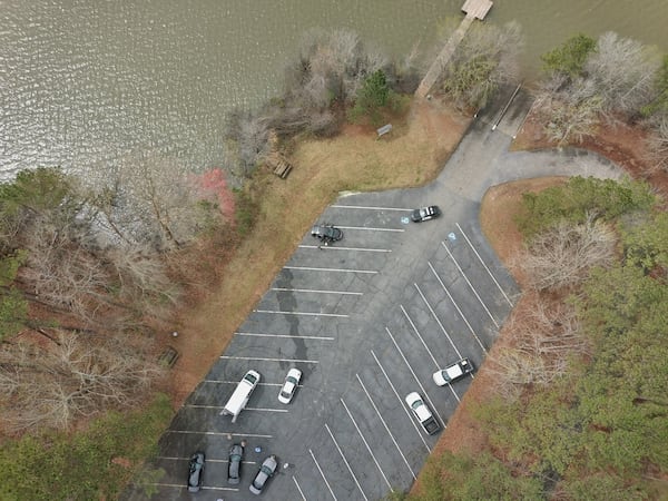 Police swarm the Holly Grove boat ramp on Lake Juliette in Monroe County, where Jadarius Watts was arrested after jumping into the water.