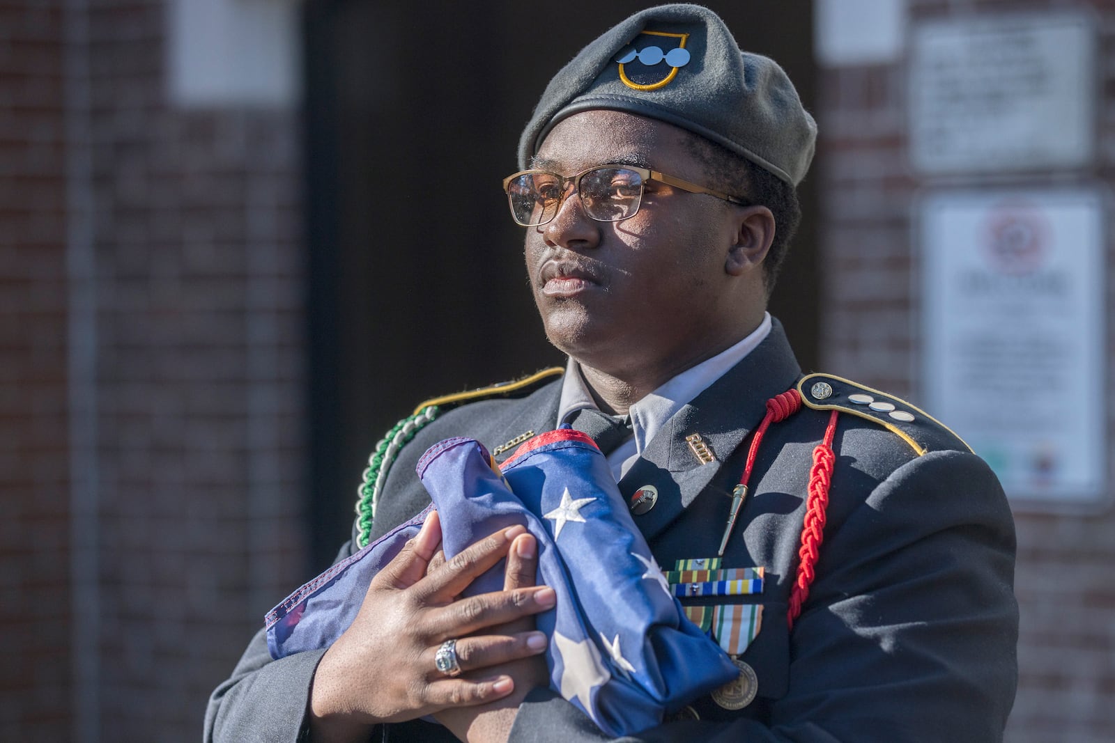 SAVANNAH, GA - FEBRUARY 01, 2024: A Windsor Forest High School JROTC member holds an American flag before it is raised during a ceremony to honor the memory of Breonna Moffett, Thursday, Feb. 1, 2024, at Windsor Forest High School in Savannah, Ga. Moffitt joined the Army Reserve in 2019 after graduating from high school. (AJC Photo/Stephen B. Morton)