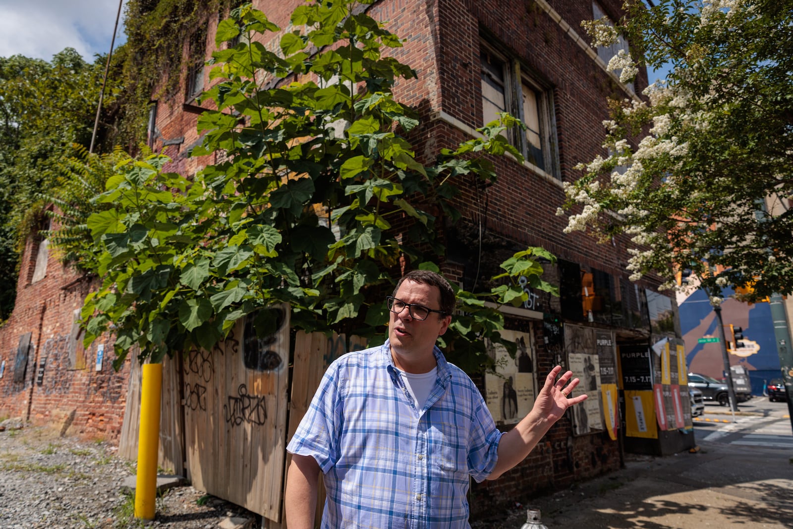 David Mitchell, executive director of the Atlanta Preservation Center, speaks to a reporter in front of 229 Auburn Avenue in Atlanta on Wednesday, July 20, 2022. The 229 Auburn Avenue building said to have housed the first Black bank in Georgia. (Arvin Temkar / arvin.temkar@ajc.com)