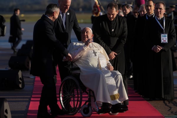 Pope Francis arrives at Ajaccio International Airport on the occasion of his one-day visit in the French island of Corsica, Sunday, Dec. 15, 2024. (AP Photo/Alessandra Tarantino)