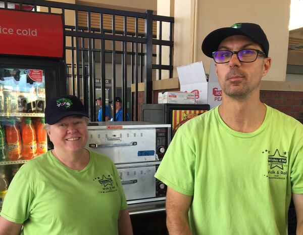 This is a photo of Jennifer Lynn Robinette (left) and resident Chris Mayo volunteering at a Gwinnett Stripers game that was provided by former Wishes 4 Me employee Mariann Marksberry.