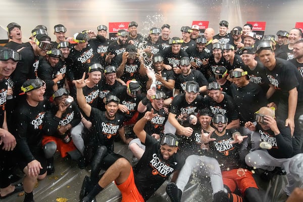 Baltimore Orioles' players celebrate after clinching a playoff berth by defeating the New York Yankees in baseball game, Tuesday, Sept. 24, 2024, in New York. (AP Photo/Bryan Woolston)