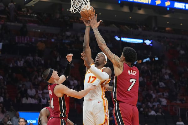 Atlanta Hawks forward Onyeka Okongwu (17) drives to the basket as Miami Heat center Kel'el Ware (7) and guard Tyler Herro (14) defend during the first half of an NBA basketball game, Wednesday, Feb. 26, 2025, in Miami. (AP Photo/Marta Lavandier)