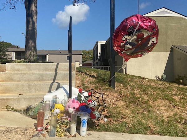 A makeshift memorial sits outside the apartment complex where Benjamin was killed while working as a security guard.