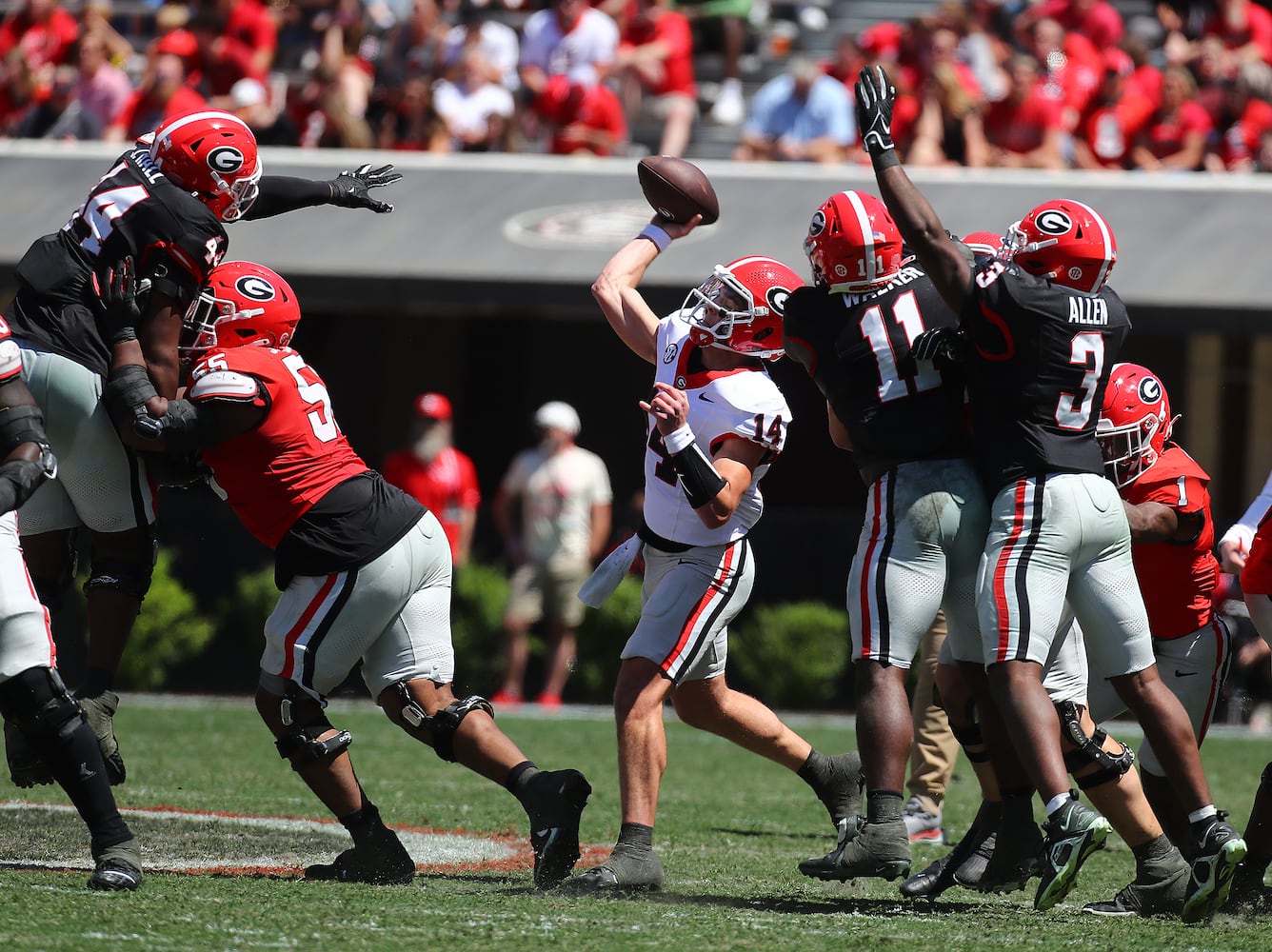 Quarterback Gunter Stockton passes under pressure during the G-Day game on Saturday, April 13, 2024.  Curtis Compton for the Atlanta Journal Constitution