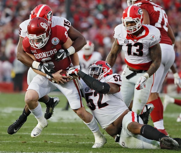 D'Andre Walker (15) and Tyler Clark (52) combine to sack Heisman Trophy winner Baker Mayfield (6) during the UGA-Oklahoma national semifinal game at the Rose Bowl Jan. 1. (Bob Andres/bandres@ajc.com).