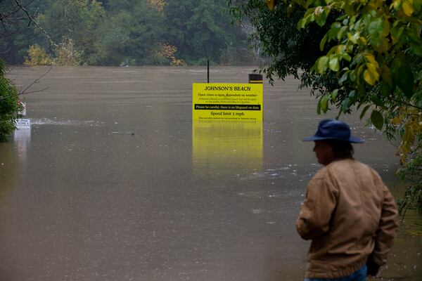 Craig Latham checks out the flooding at Johnson's Beach in Guerneville, Calif., on Friday, Nov. 22, 2024. (Santiago Mejia/San Francisco Chronicle via AP)