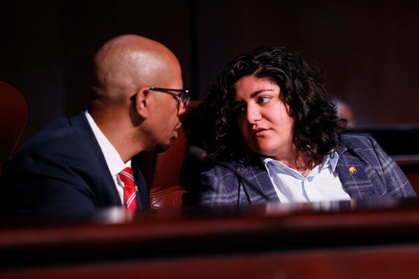 Atlanta Council members Liliana Bakhtiari and Jason Dozier talk during a meeting on Monday, August 15, 2022.  One of the subjects on the agenda that attracted the attention of activists and the public is leasing Atlanta jail beds to Fulton County jails. Miguel Martinez / miguel.martinezjimenez@ajc.com