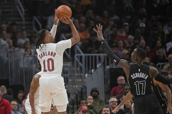 Cleveland Cavaliers' Darius Garland (10) shoots over Brooklyn Nets' Dennis Schroder (17) during the first half of an NBA basketball game in Cleveland, Saturday, Nov. 9, 2024. (AP Photo/Phil Long)