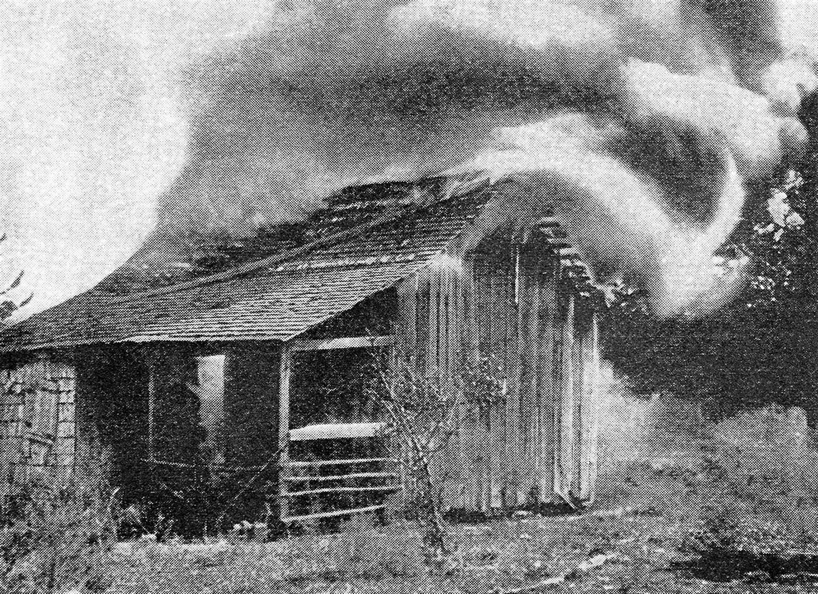 The house of a black resident of Rosewood goes up in flames during a massacre by a white mob in 1923. (Florida Memory)