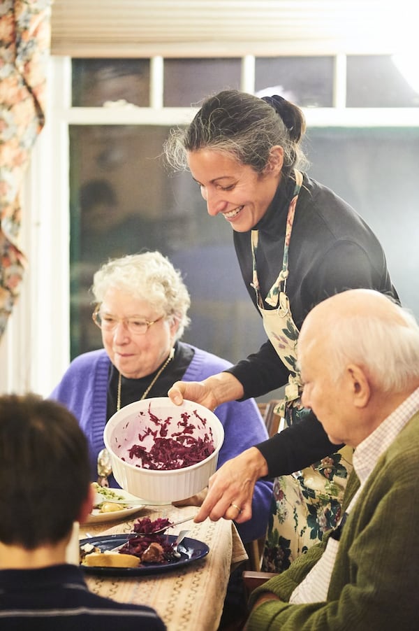 Ligaya Figueras serving a dinner she made in late 2011 to her parents, Dorothy and Richard Figueras. CONTRIBUTED BY GREG RANNELLS