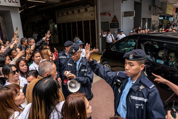 Supporters of former populist President of the Philippines Rodrigo Duterte waits for his arrival at a thanksgiving gathering organized by Hong Kong-based Filipino workers as Filipino actor, Robin Padilla arrives in a car in Hong Kong on Sunday, March 9, 2025. (AP Photo/Vernon Yuen)