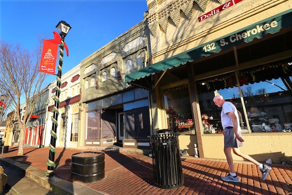 Local resident Ken Edwards makes his way through the mostly quiet main street commercial district in Social Circle, Georgia, while out for his five-mile run/walk on Tuesday, Jan. 18, 2022. The nearby Rivian project excites developers, but local residents are mostly apprehensive. (Curtis Compton / Curtis.Compton@ajc.com)