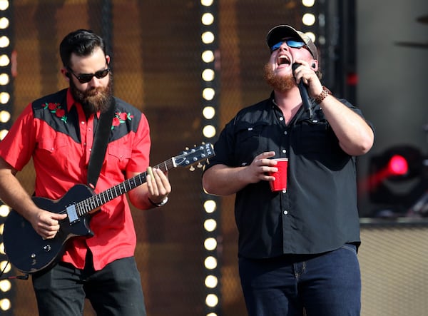 Luke Combs had a few sips during his opening set. Photo: Robb Cohen Photography & Video/ www.RobbsPhotos.com